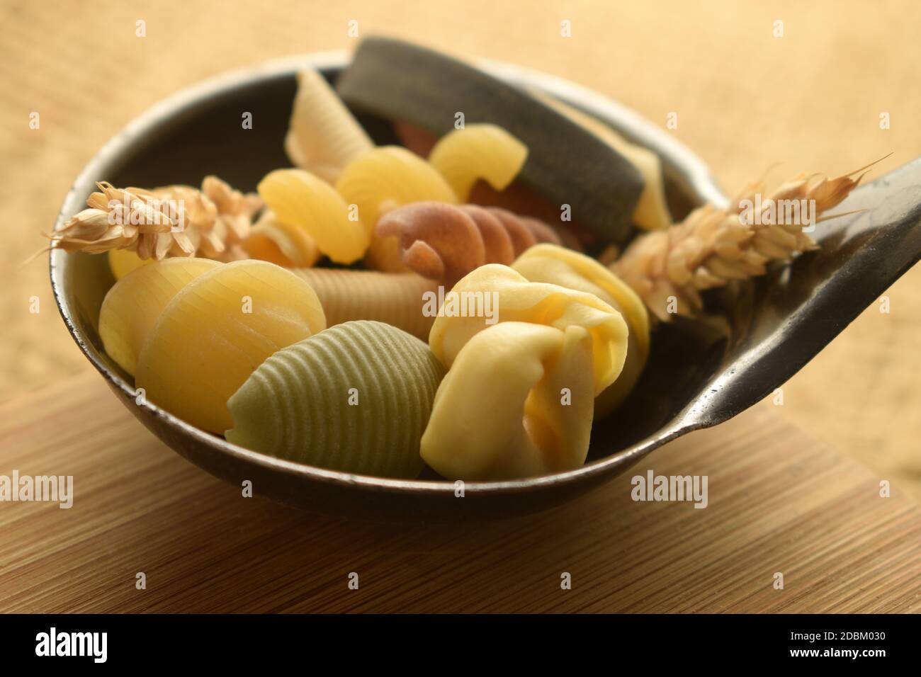 Mixed pasta with wheat in the ladle Stock Photo