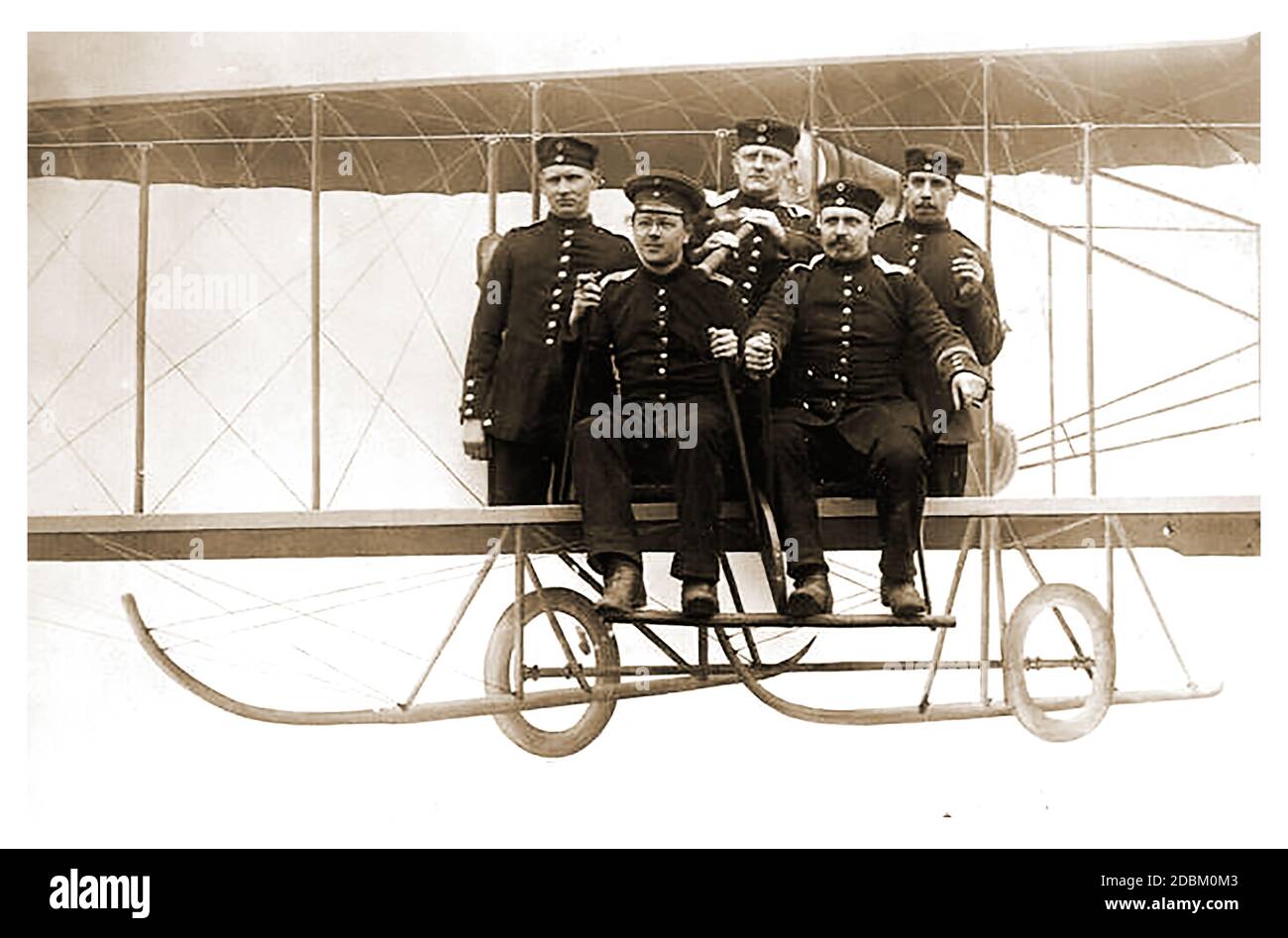 WWI  - Deutsche Luftstreitkräfte aka Die Fliegertruppen des deutschen Kaiserreiches , Imperial German Flying Corps or Die Fliegertruppe . A rare  old photograph of 5 members of Germany's early aerial military squad flying in an experimental  lighter-than -air biplane craft.  World War One airplanes began as primitive, unarmed artillery spotters and developed into  powerful bombers and  fighters Stock Photo