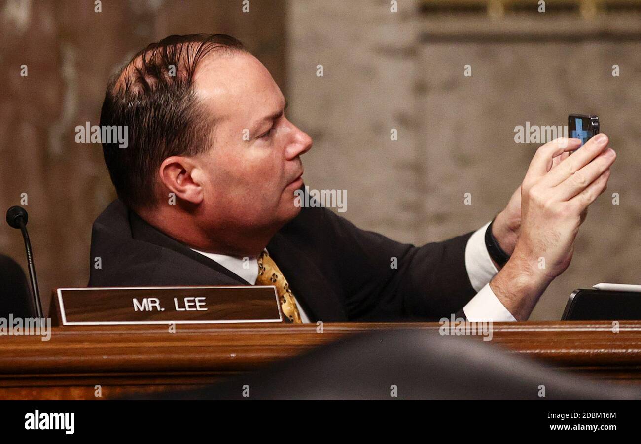 United States Senator Mike Lee (Republican of Utah) snaps a picture during a US Senate Judiciary Committee hearing titled, 'Breaking the News: Censorship, Suppression, and the 2020 Election,” on Facebook and Twitter's content moderation practices, on Capitol Hill in Washington, U.S., November 17, 2020. Credit: Hannah McKay/Pool via CNP /MediaPunch Stock Photo