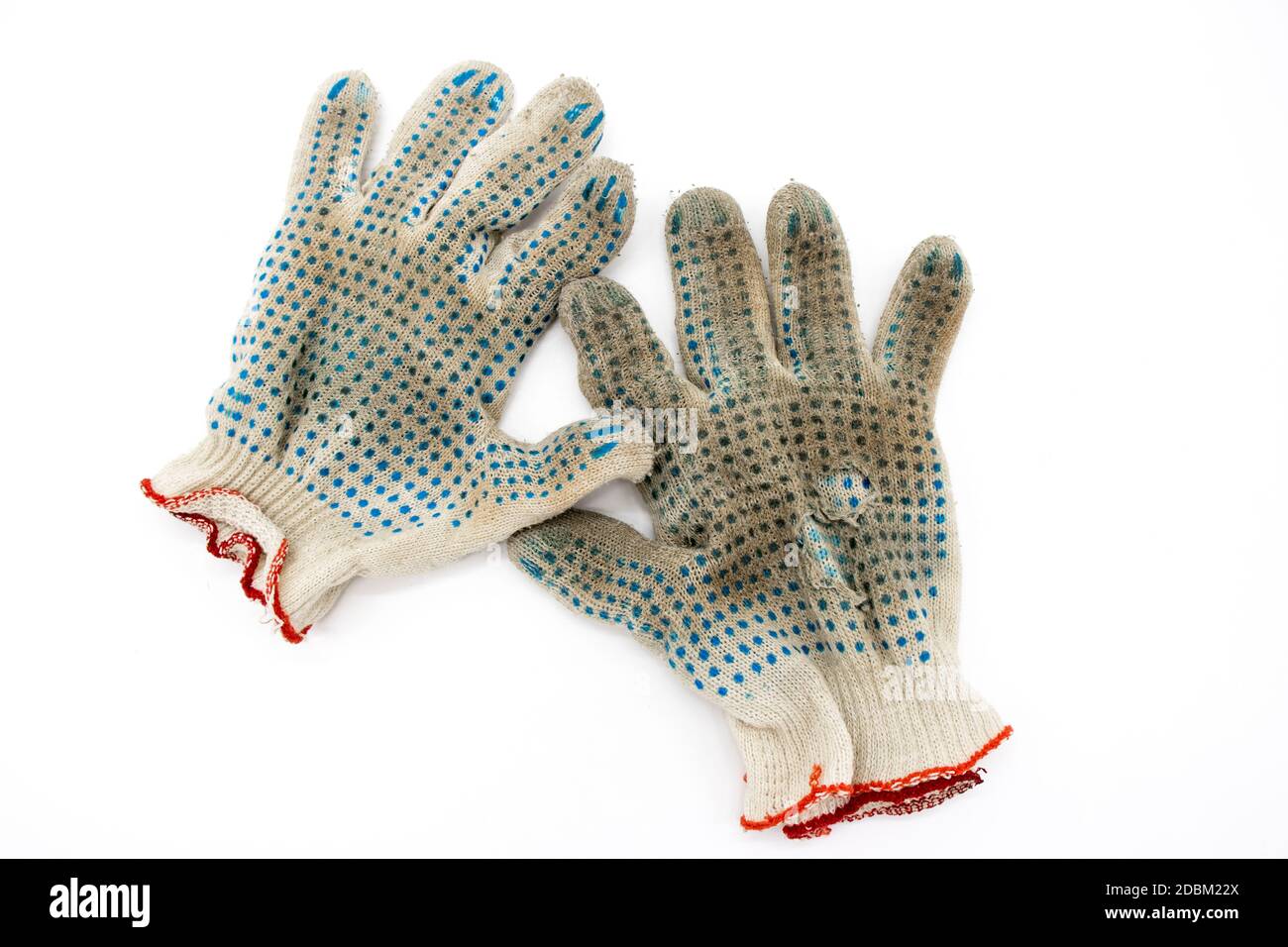 Worn, torn gloves on a white background Stock Photo