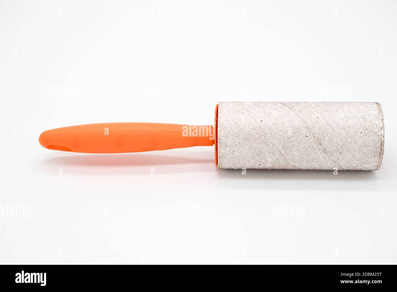 Cleaning sticky roller with orange handle on white background Stock Photo