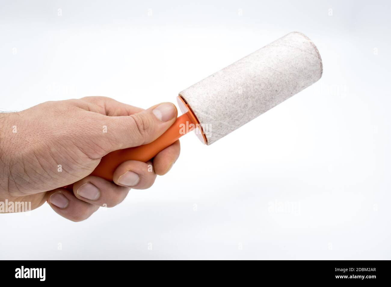 Cleaning sticky roller with orange handle on white background Stock Photo