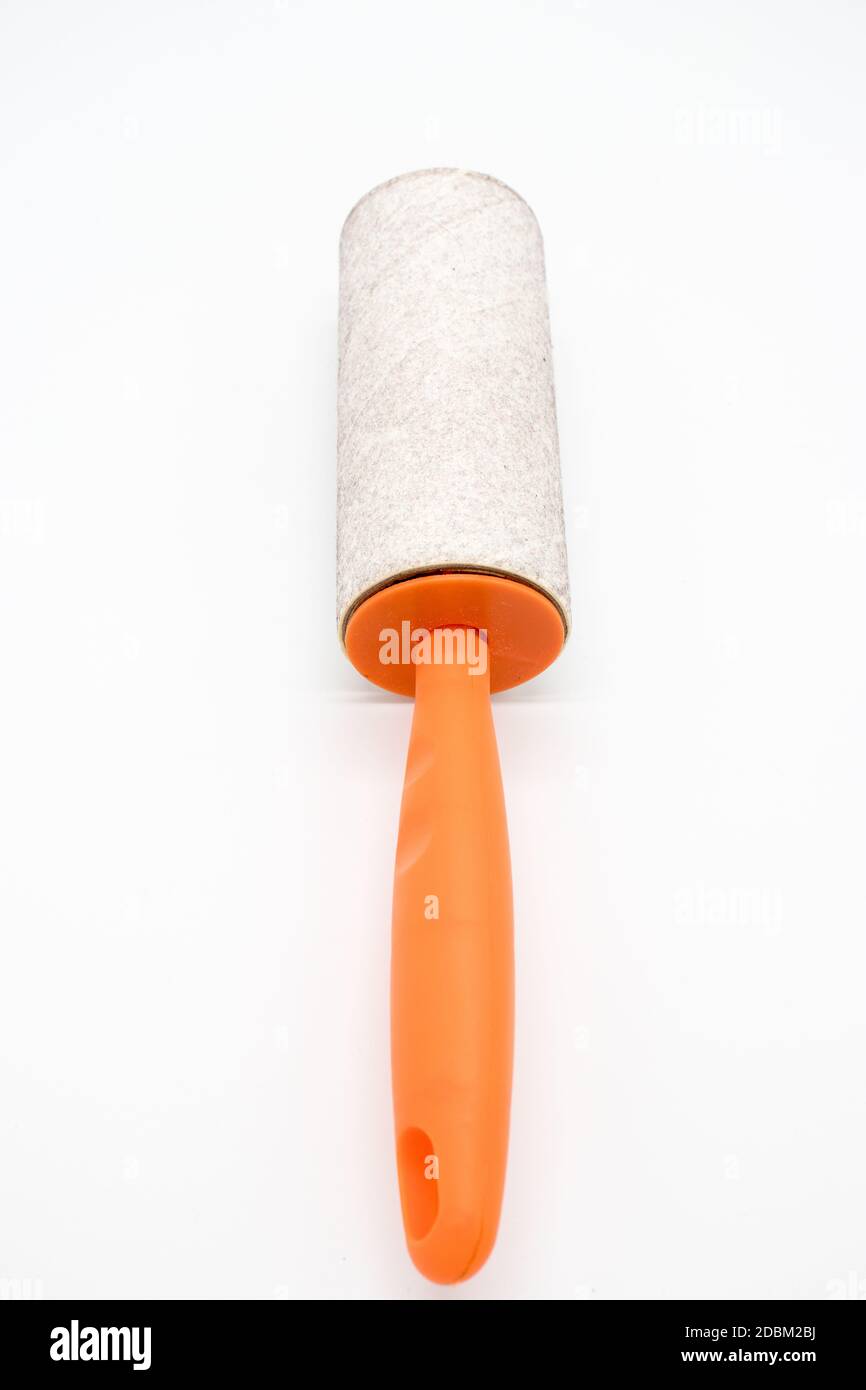 Cleaning sticky roller with orange handle on white background Stock Photo