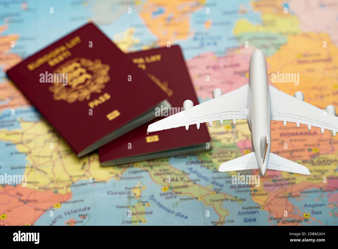 Toy of a plane flying over the Europe map with passports. Stock Photo