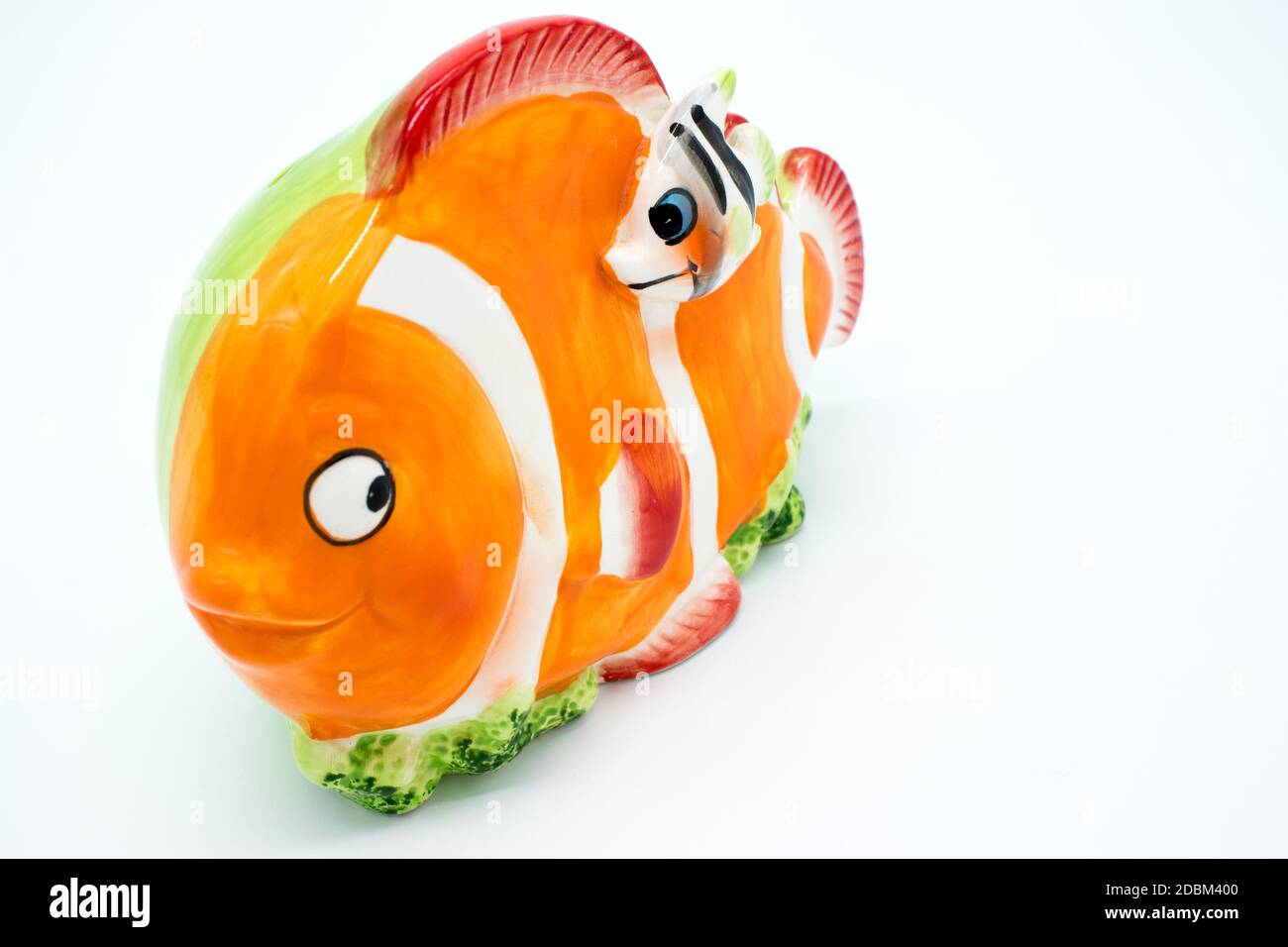 Porcelain piggy bank in the shape of a clown fish on a white background  Stock Photo - Alamy