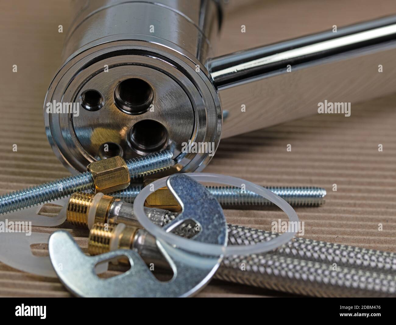 Basin mixer with fastening material and connection hoses Stock Photo