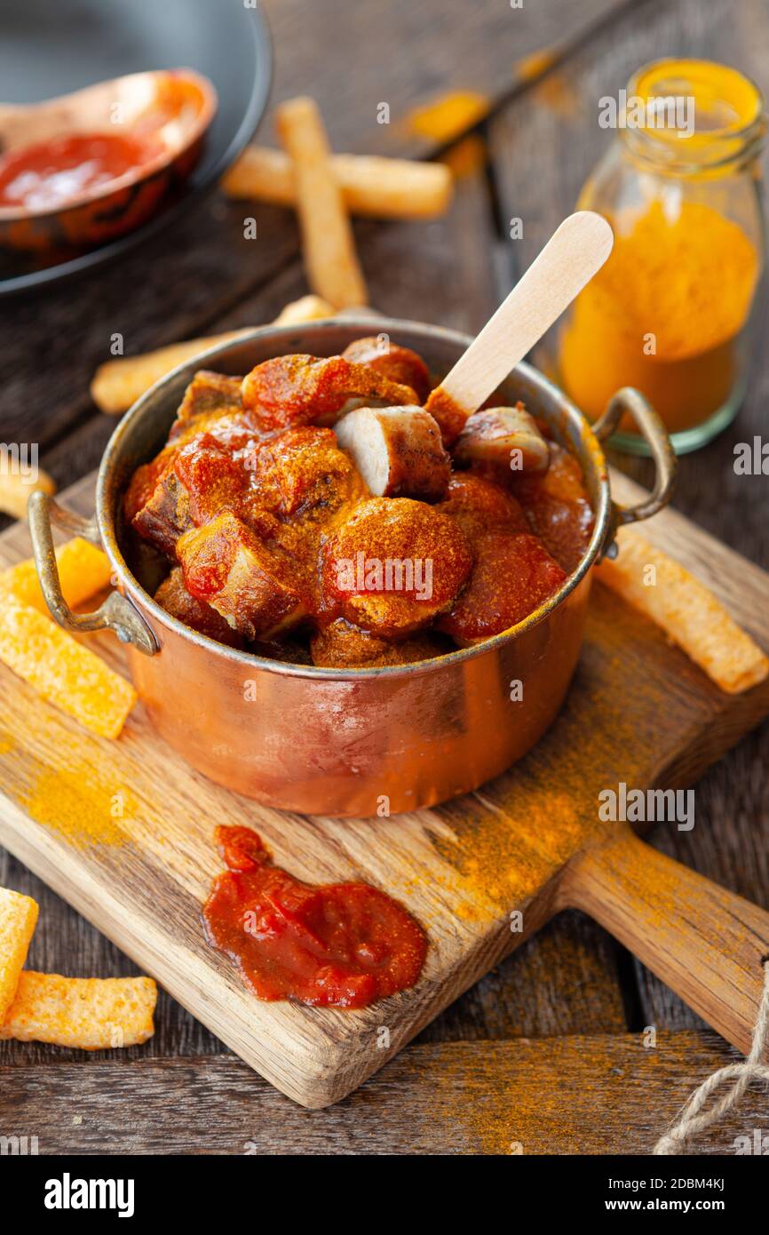 Delicious bratwurst with a spicy tomato curry sauce Stock Photo - Alamy