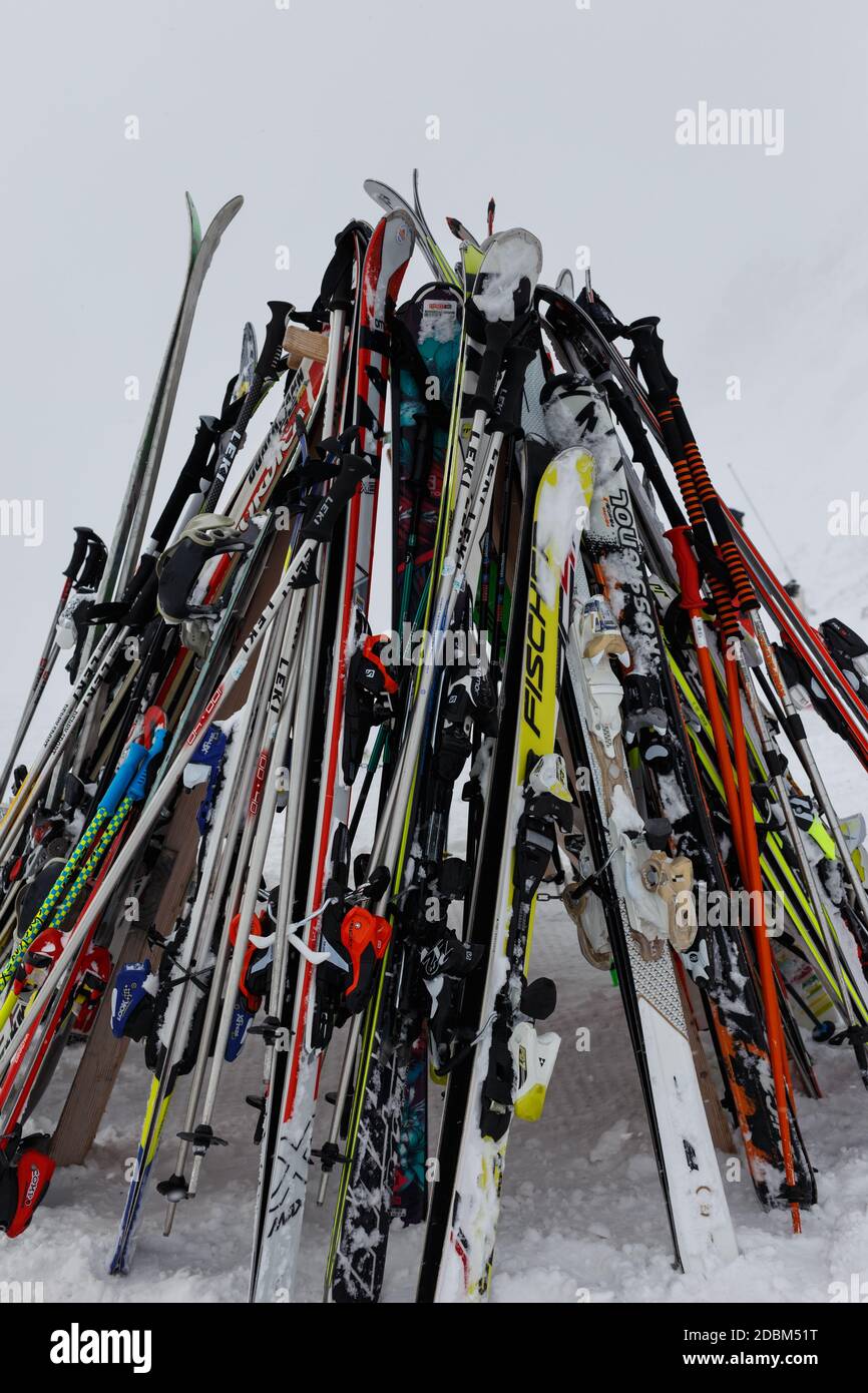 A group of skis and ski poles piled up on a foggy day Stock Photo