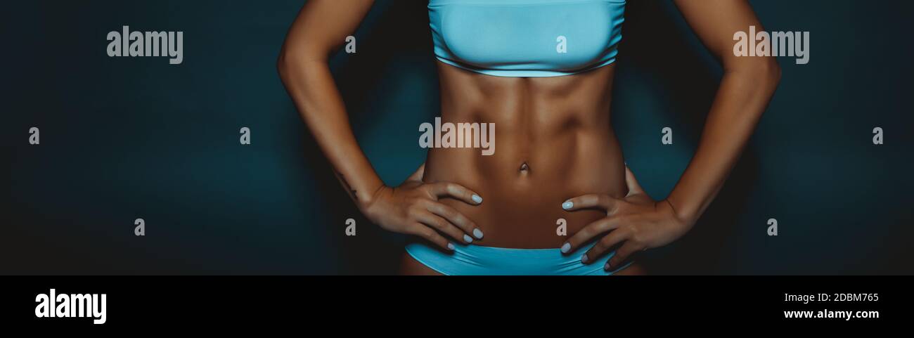 https://c8.alamy.com/comp/2DBM765/female-body-with-perfect-abs-fit-girl-with-six-pack-isolated-on-dark-background-healthy-active-lifestyle-sportive-life-panoramic-photo-2DBM765.jpg