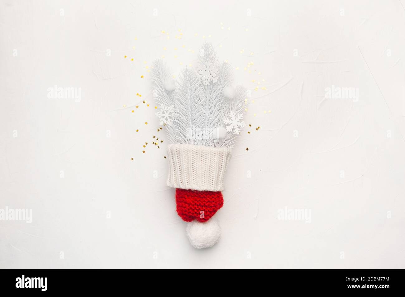 Christmas greeting card with red hat and white fir branches and snowflakes on white backgroun. Xmas holiday postcard with place for your text. Happy Stock Photo