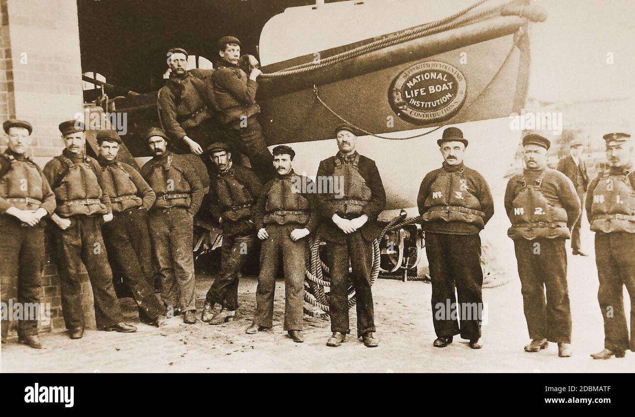 Whitby, Yorkshire lifeboat crew in 1911. They are pictured outside of the lifeboat house at the bottom of Khyber Pass, now used as a lifeboat museum. The lifeboat in the picture is likely to be the  John Fielden 1895–1914 which was damaged and unrepairable following the rescue of survivors from the wreck of the hospital ship Rohilla in 1914,  or the Robert & Mary Ellis II, which replaced her and was  in service from 1908-1943 Stock Photo