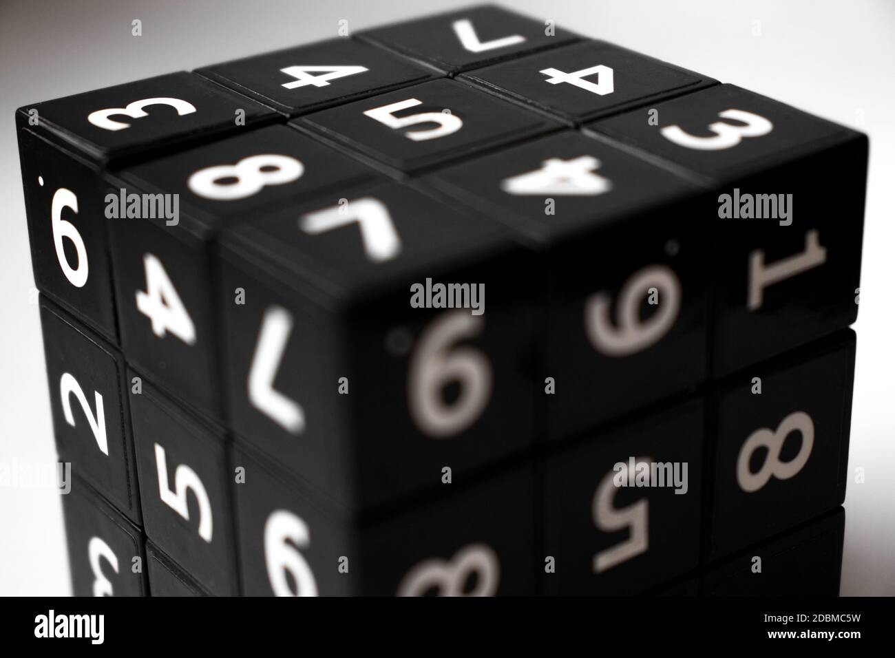 Black cube with numbers in its area for playing the Japanese Sudoku game on a white background Stock Photo
