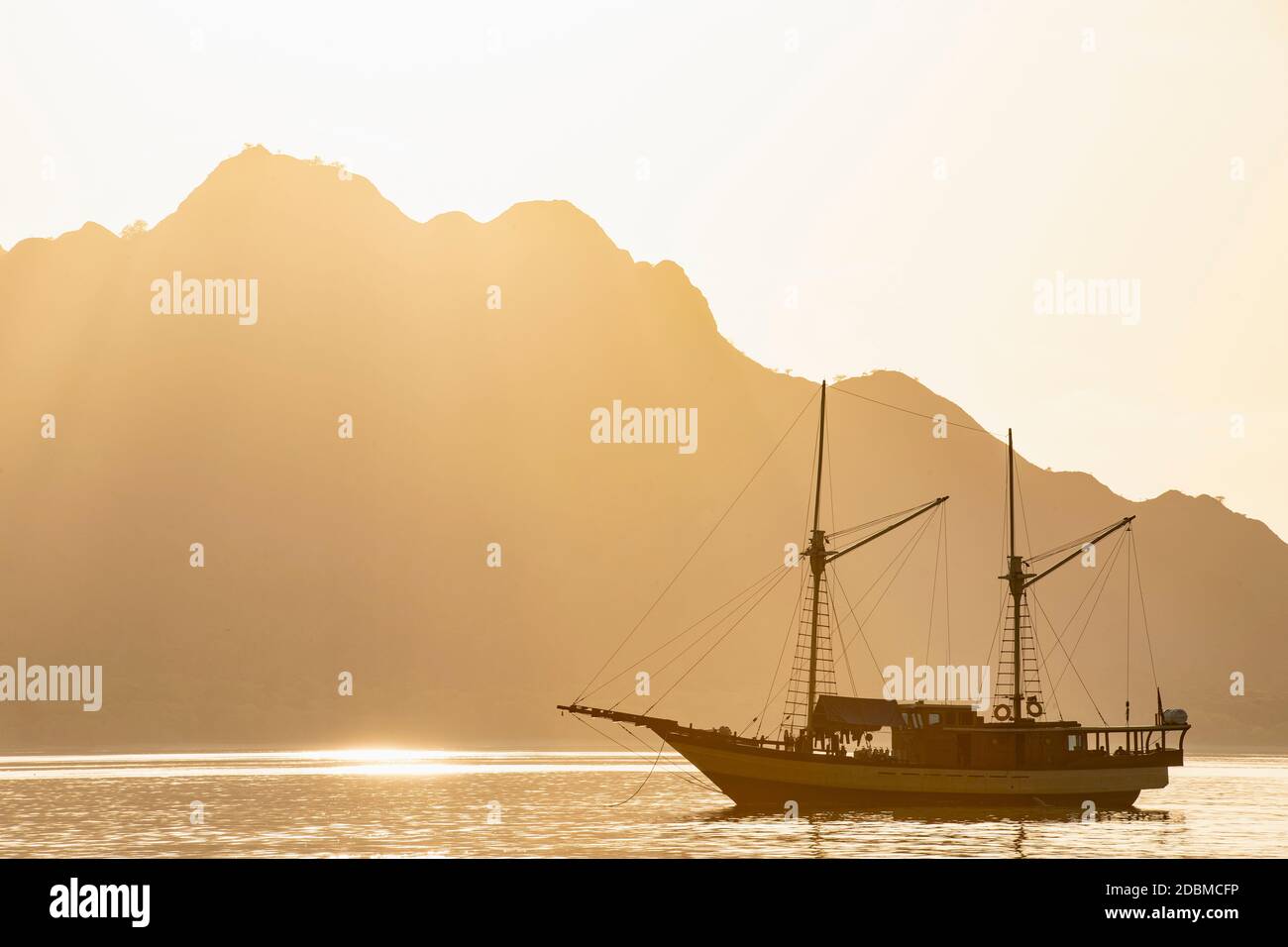 a sailboat anchored in the bay at Komodo Island Stock Photo - Alamy