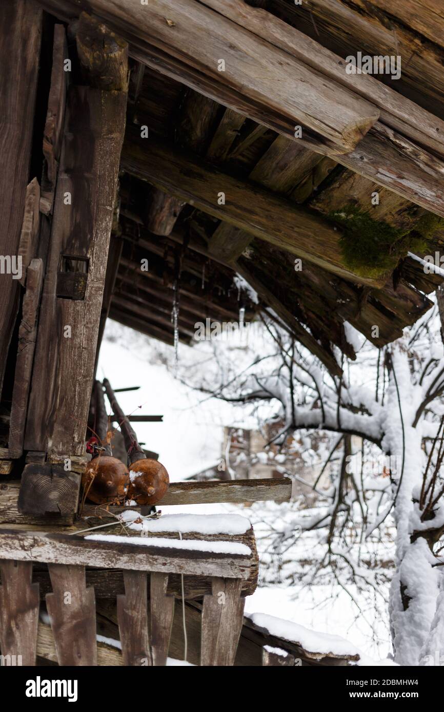 Part view of of an old house wooden roof with icicles and fresh snow, Val Gardena, Dolomites, Italy Stock Photo
