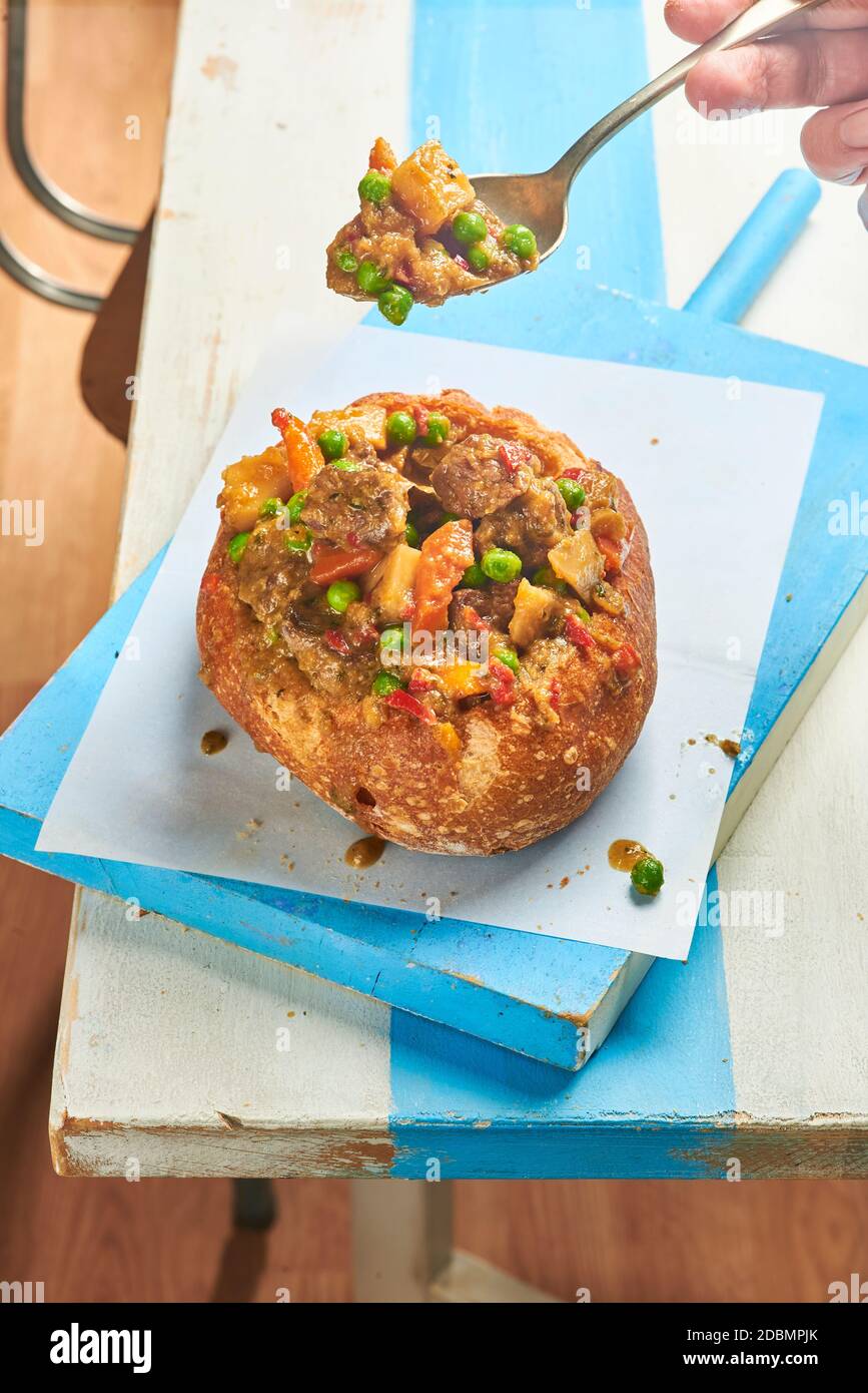 Goulash served in a bread bowl, a traditional beef stew of the