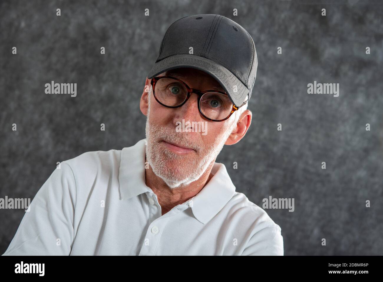a sixty year old man wearing a baseball cap Stock Photo