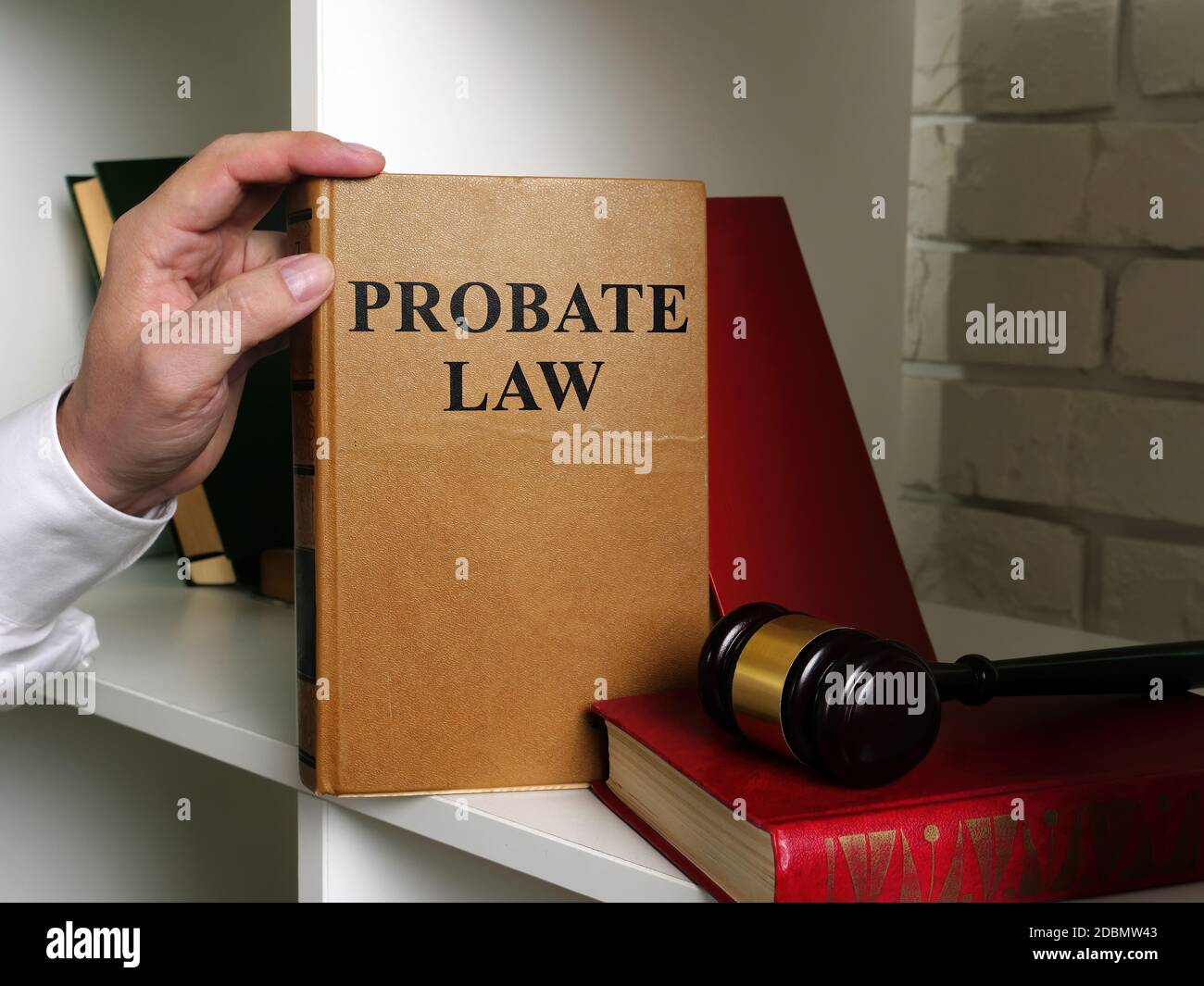 Lawyer takes a book Probate law from a shelf Stock Photo Alamy