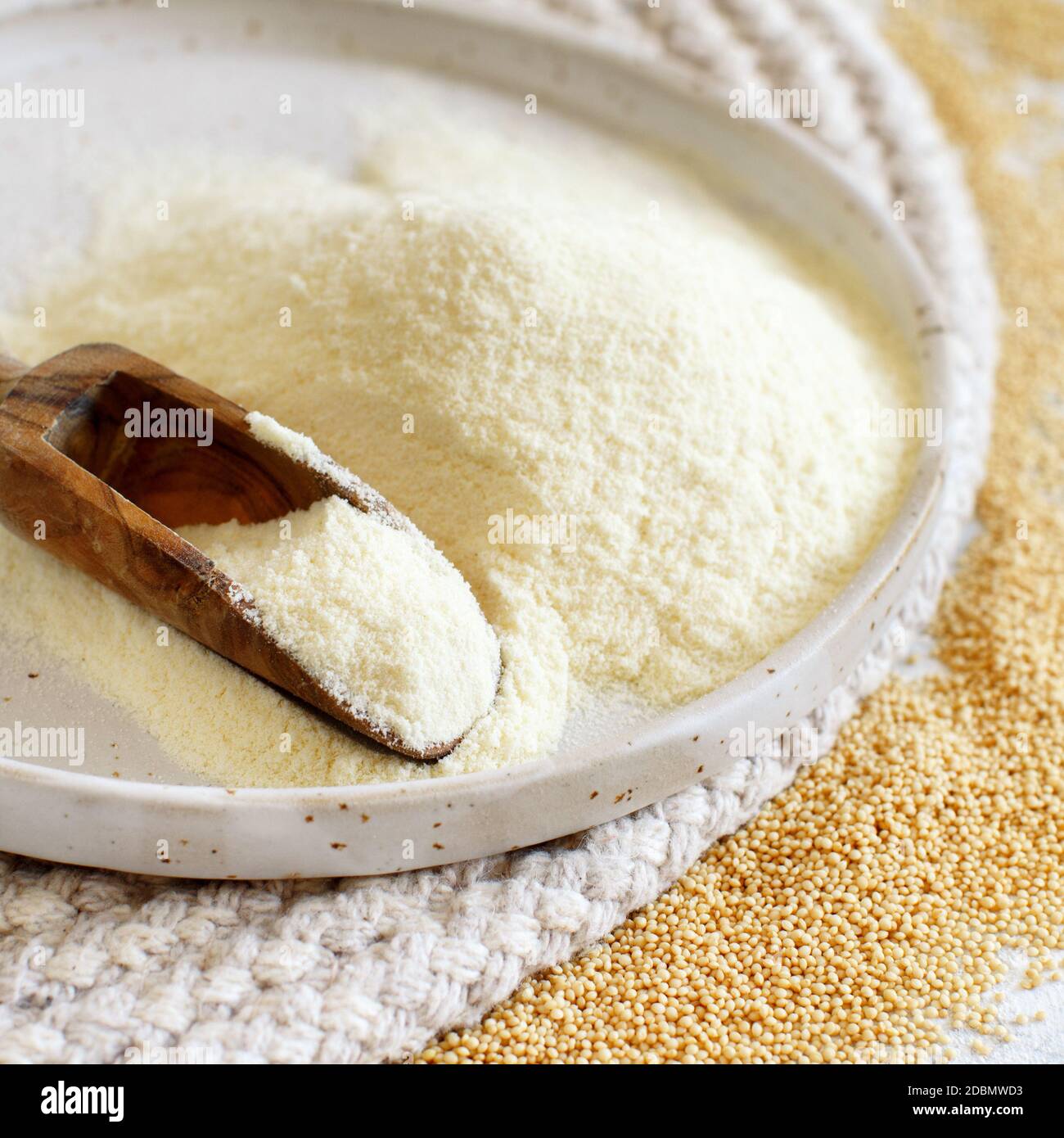 Plate of raw Amaranth flour with a spoon and Amaranth seeds close up Stock Photo