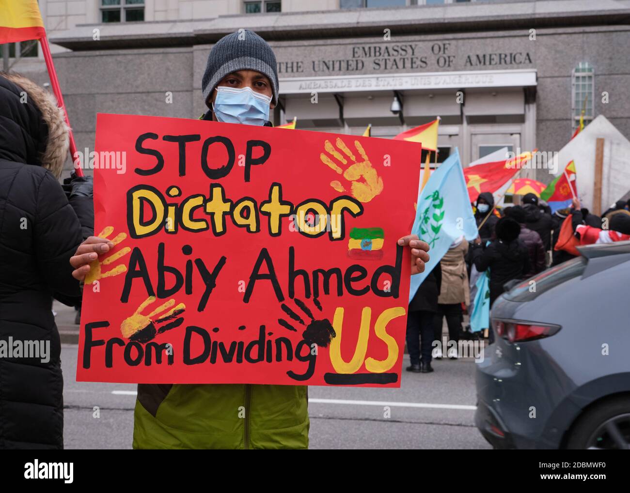 Ottawa, Canada. November 17th, 2020. Protester with a sign 'Stop Dictator Abiy Ahmad from dividing US' part of Over 300 people took to the streets of Ottawa to protest the war in Tigray region of Ethiopia and the offensive undertaken by Prime Minister Abiy Ahmed against them. They stopped in front of the Embassy of the United States of America to demand intervention in the conflict. Abiy, last year's Nobel Peace Prize winner, continues to reject international pleas for dialogue and de-escalation in the two-week conflict. Credit: meanderingemu/Alamy Live News Stock Photo