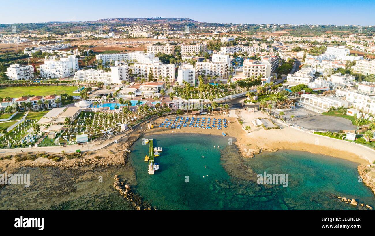 Aerial bird's eye view of Pernera beach in Protaras, Paralimni, Famagusta, Cyprus. The famous tourist attraction golden sandy bay with sunbeds, water Stock Photo