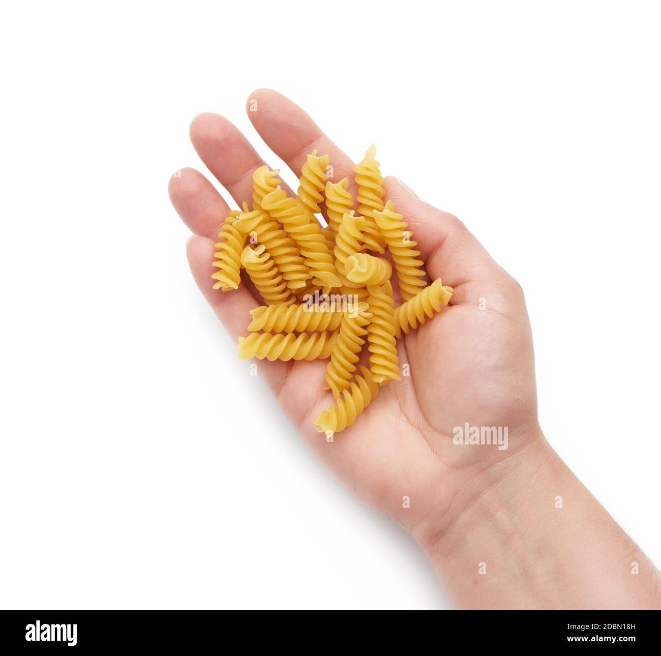 hand holds raw fusilli pasta, part of the body isolated on white