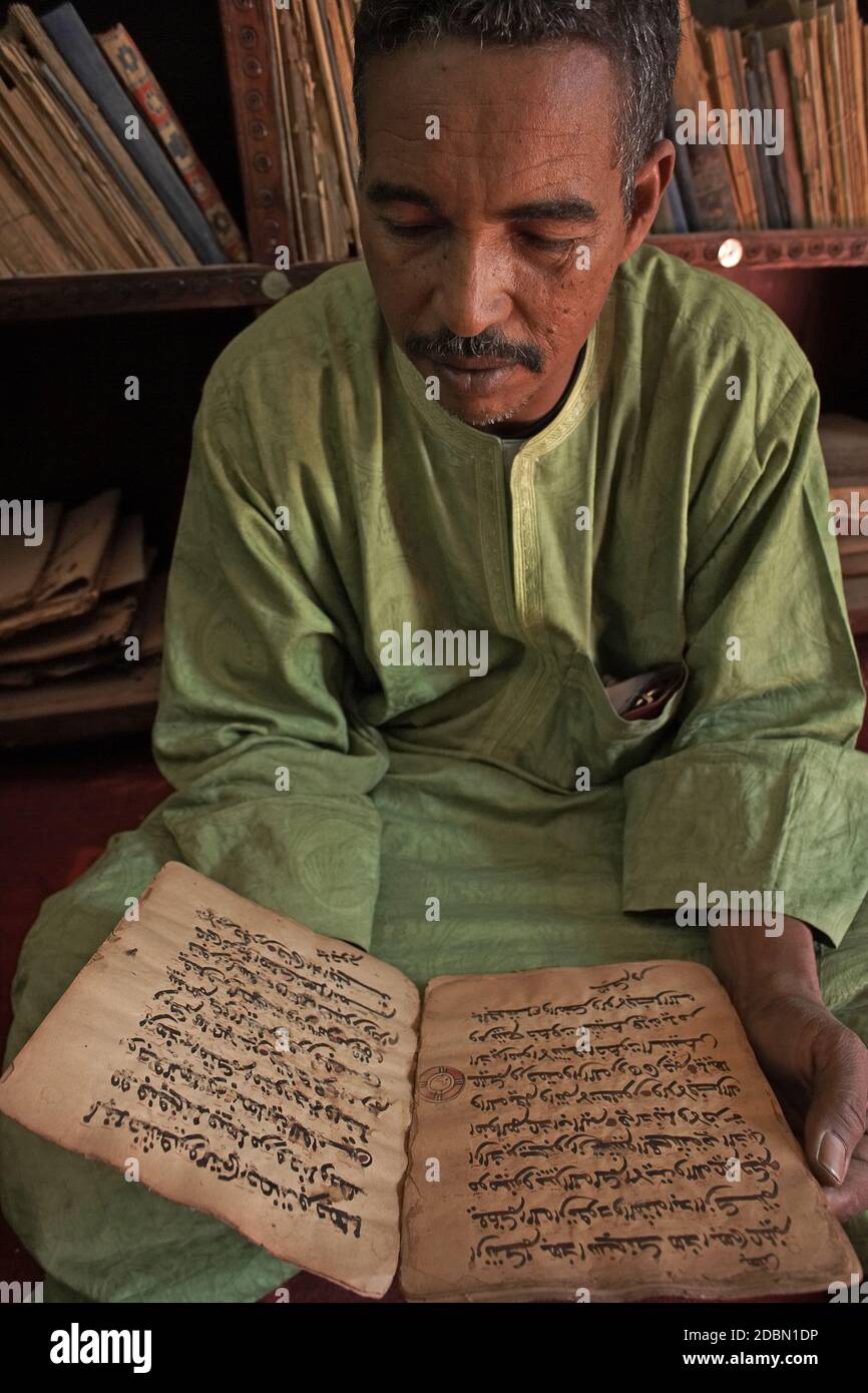 Man is reading Islamic manuscript  from 16th century in Timbuktu ,Mali, West Africa. Stock Photo