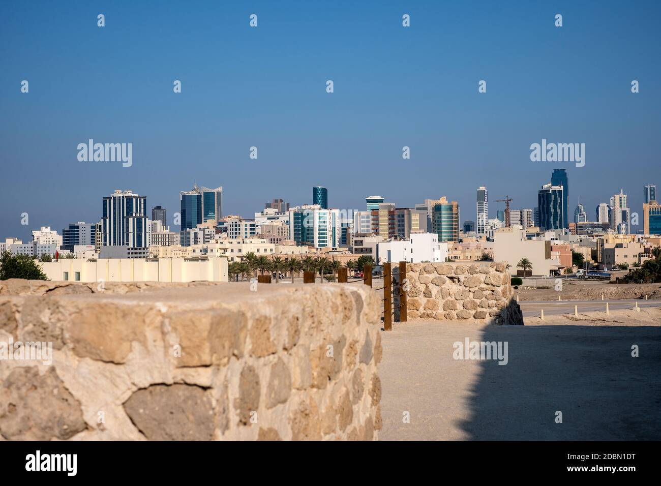 The modern city of Manama, Bahrain viewed from the ruins of the Bahrain fort Stock Photo