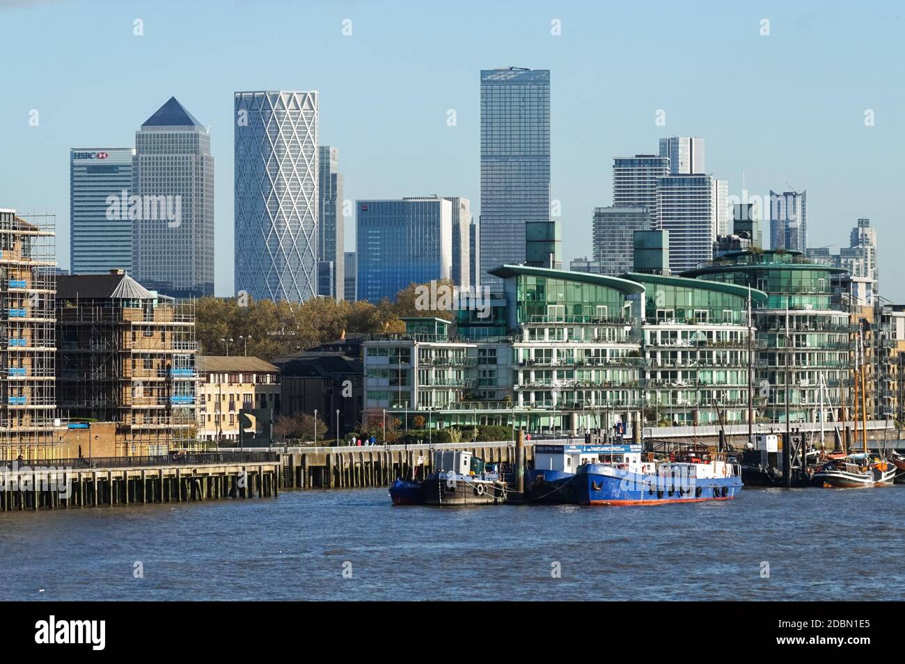 Canary Wharf skyscrapers seen behind residential buildings in London, England, United Kingdom, UK Stock Photo