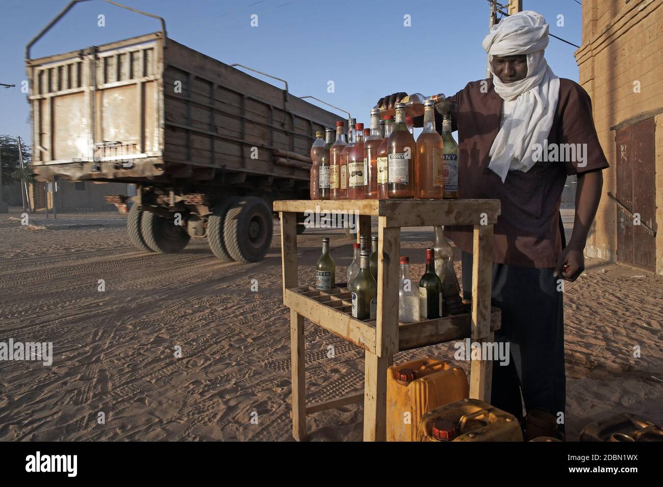 Men selling petrol in bottels on a road in Timbuktu, Mali, West Africa Stock Photo