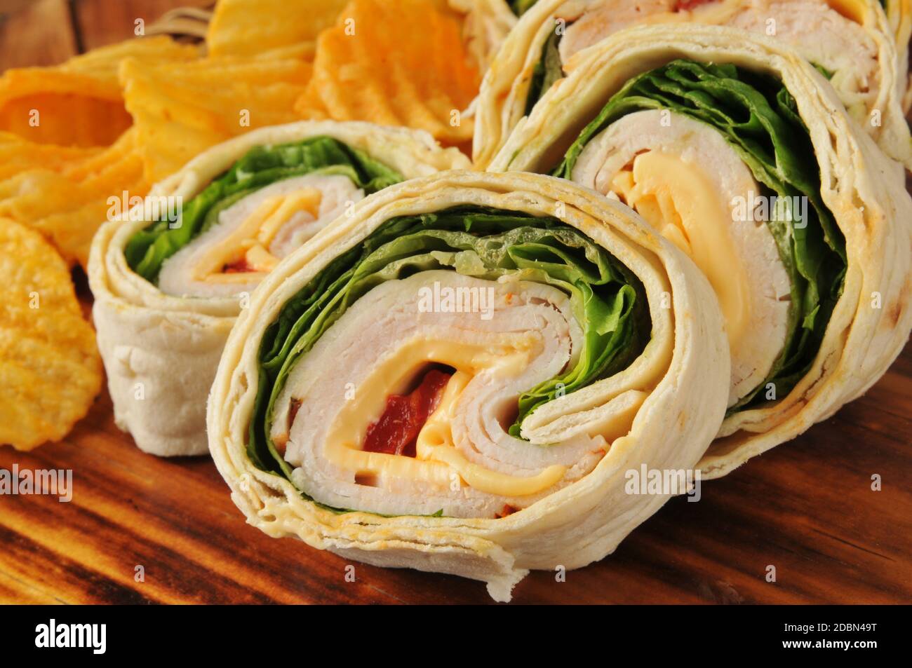 Sliced chicken wrap sandwich with cheddar cheese tortilla chips Stock