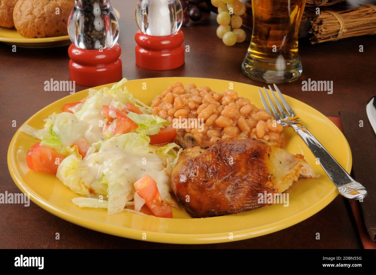 Baked chicken with baked beans, salad and beer Stock Photo - Alamy