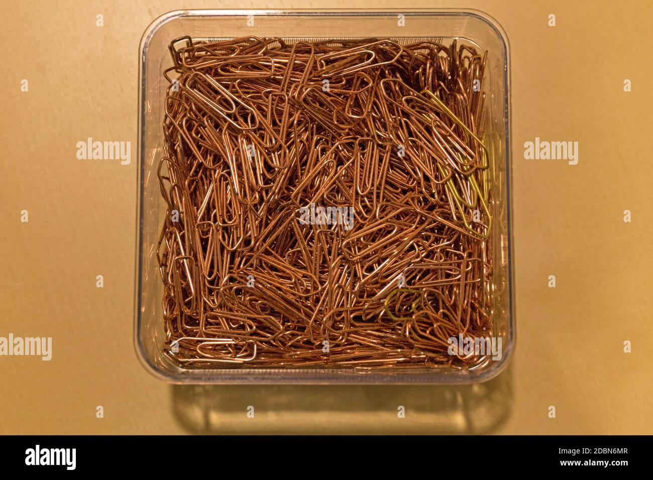 Bunch of Paper Clips in Box at Desk Stock Photo