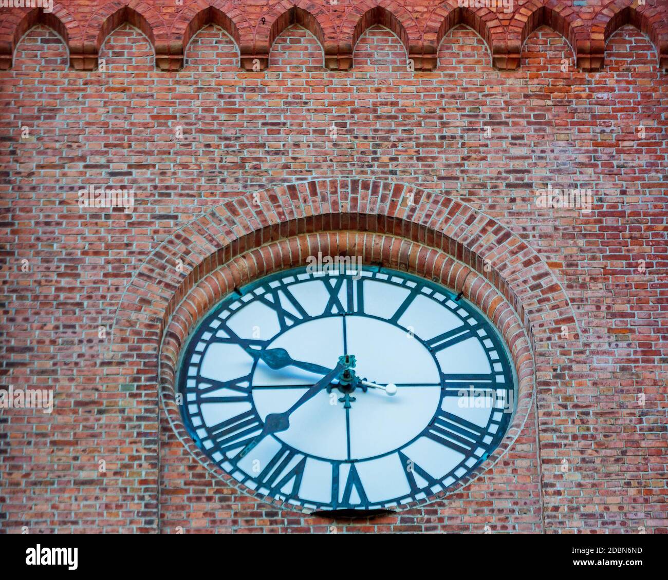 White Clock Dial Roman Numbers at Brick Wall Stock Photo Alamy