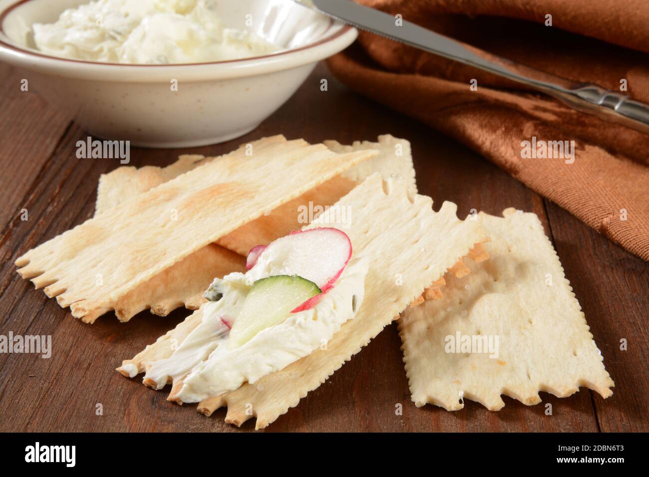 Gourmet flatbread crackers with cream cheese, radish and cucumber Stock