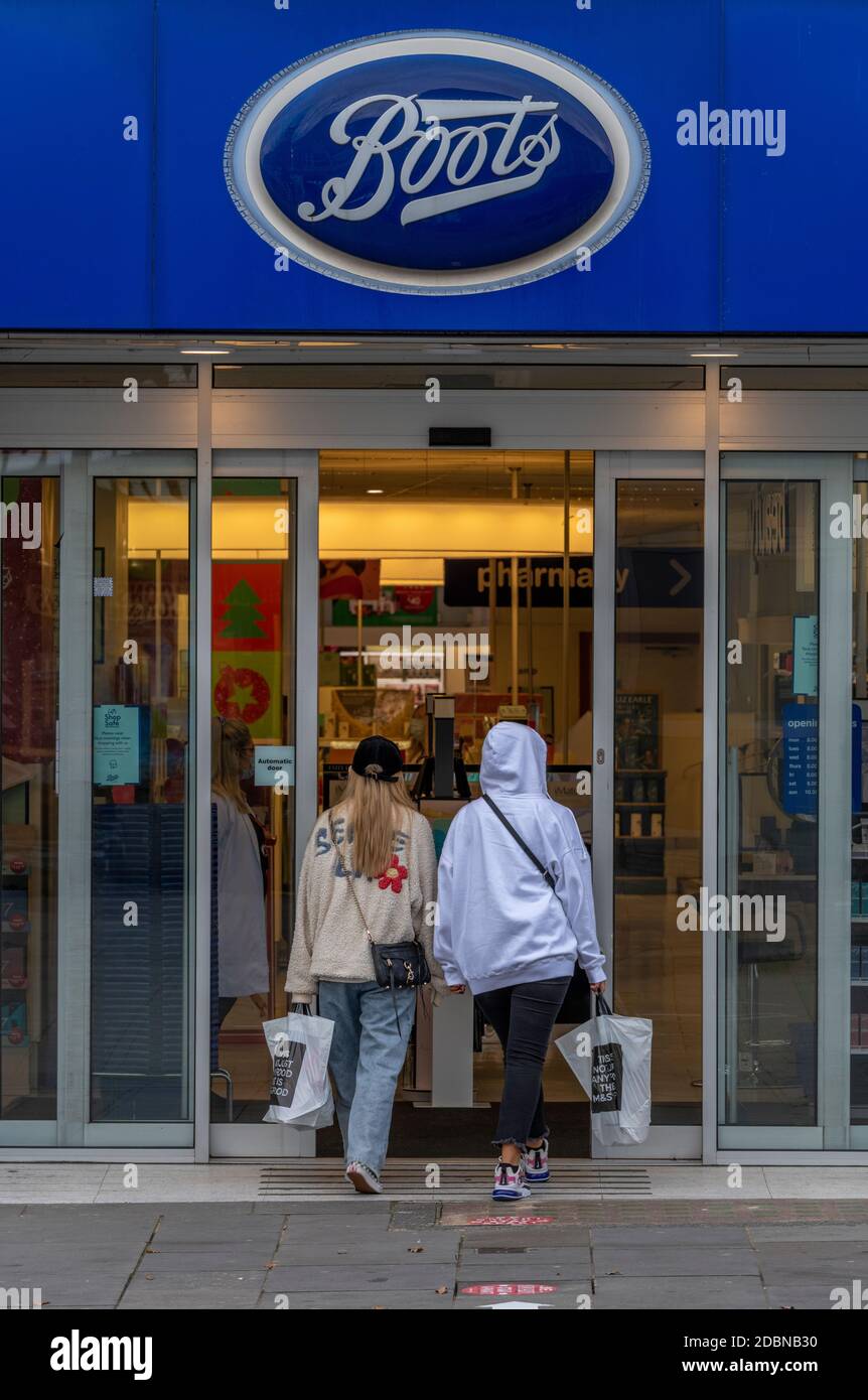 two women entering a large high street boots the chemist store in  southampton city centre Stock Photo - Alamy