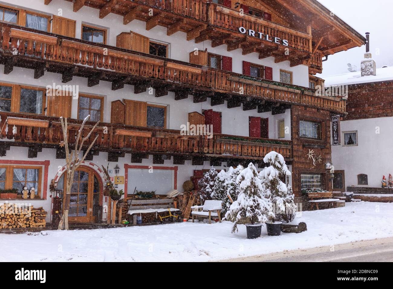Traditionan Tyrolean hotel on an overcast and snowy day, Selva Gardena, Dolomites, Italy Stock Photo