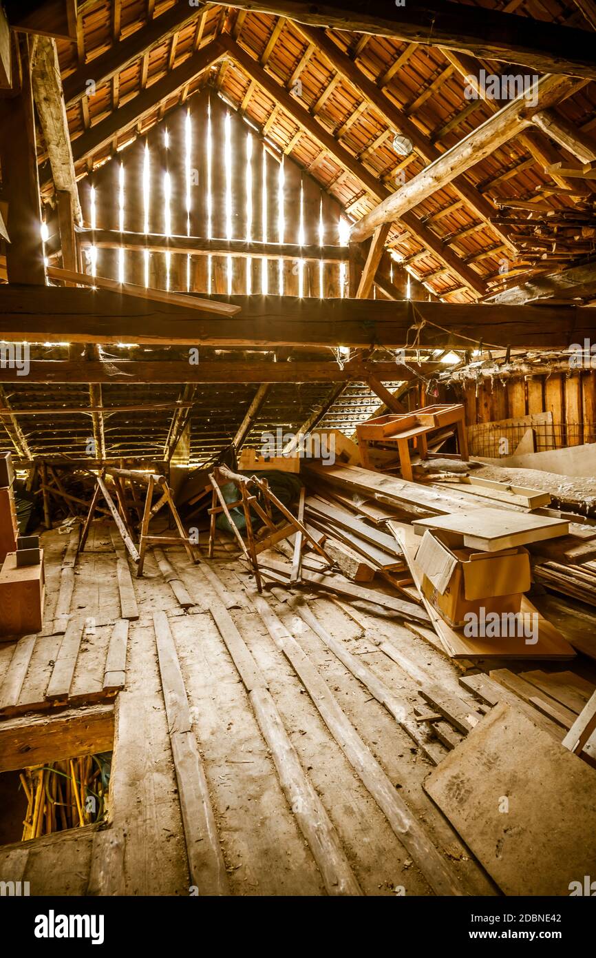 Interior of old wooden shed with scrap wood with sunrays. Old barn. Stock Photo