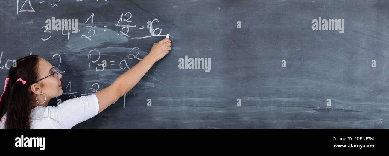 Long frame. Mathematical task. Blackboard. Young teenage girl. He ...