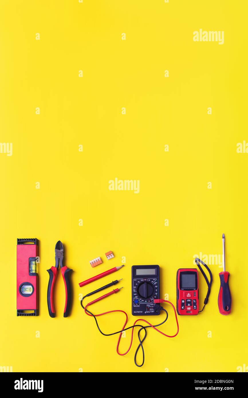 Set of electrician's tools on yellow background. Flat lay composition ...