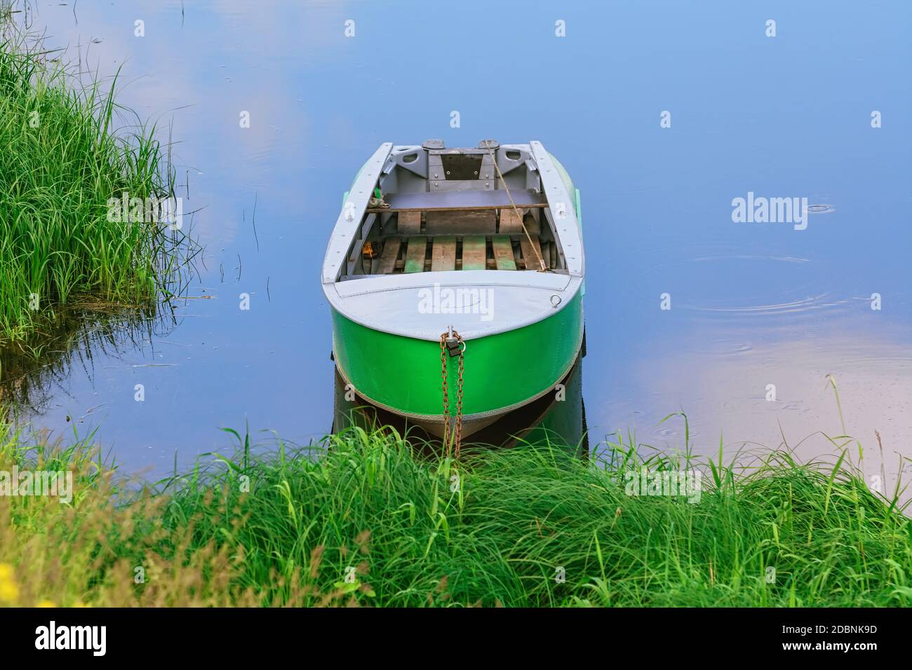 Closeup of a docked metal fishing boat floating in the water Stock