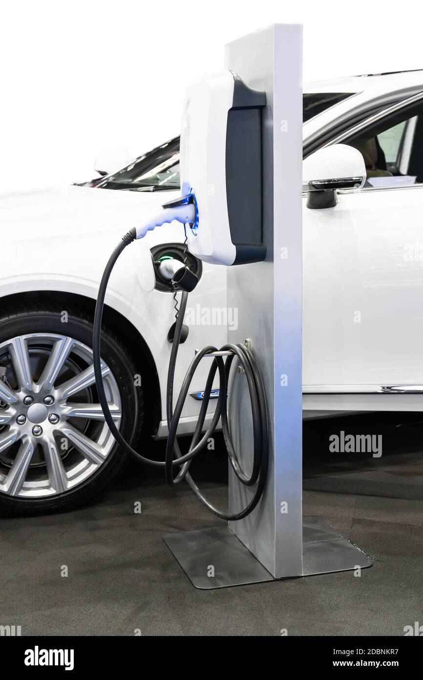 Close up of the power supply plugged into an electric car, Power supply connect to electric car for add charge to the battery on white Stock Photo