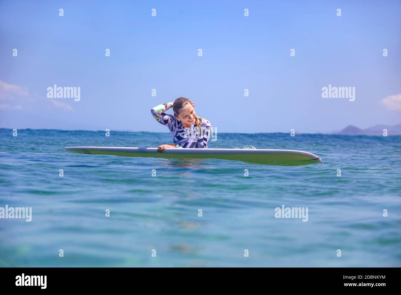 Woman swimming on a surfboard hi-res stock photography and images - Alamy