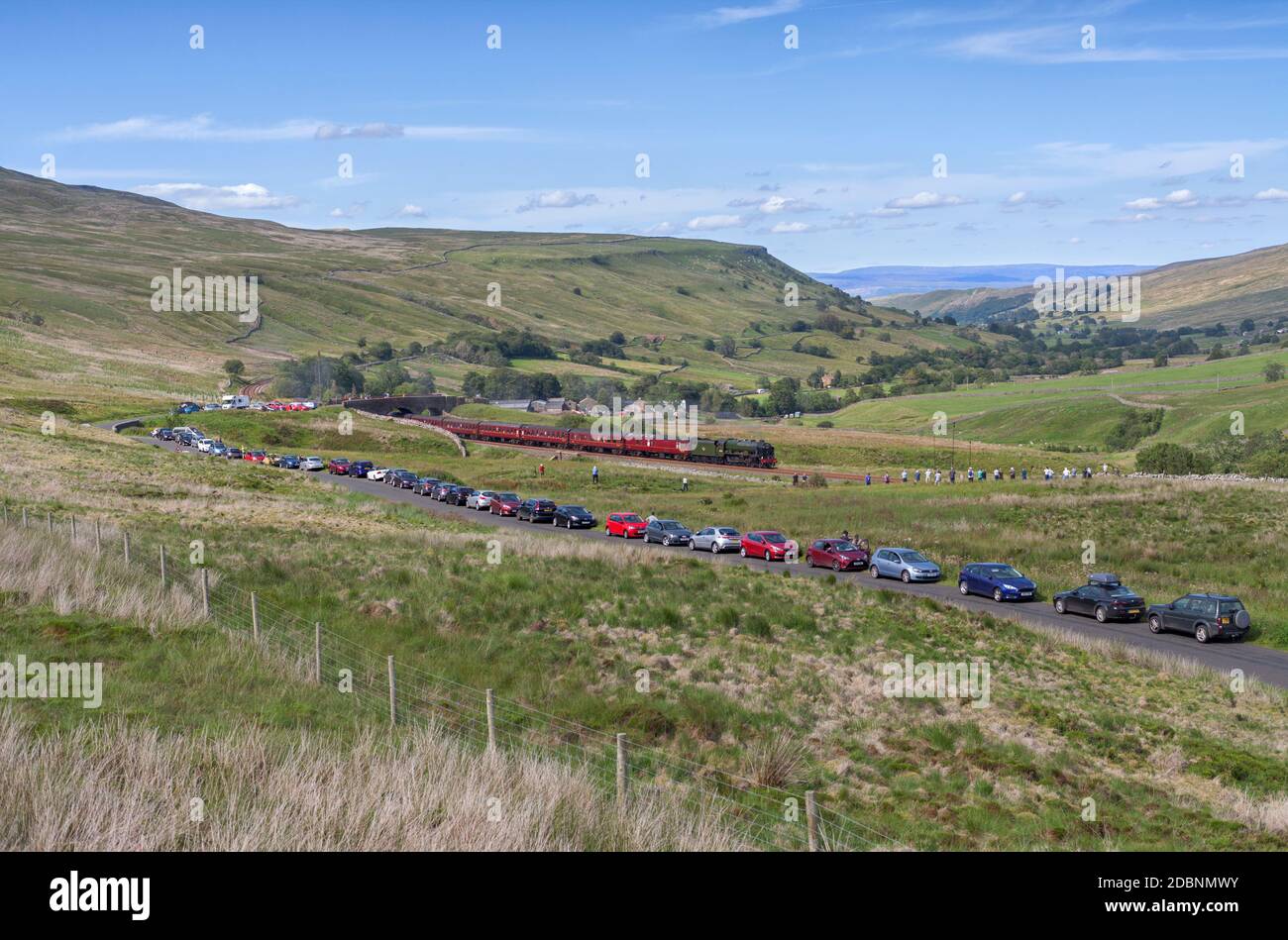 Rail enthusiasts / train spotters photographing a mainline steam train passing Ais Gill summit on the scenic Settle to Carlisle railway line Stock Photo