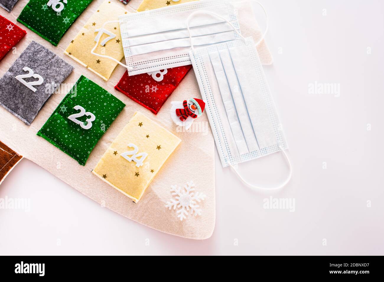 Traditional advent calendar protected with medical face masks, isolated