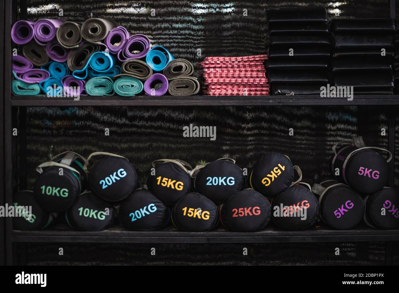 Weights and exercise mats on shelves in gym, Canggu, Bali, Indonesia Stock Photo