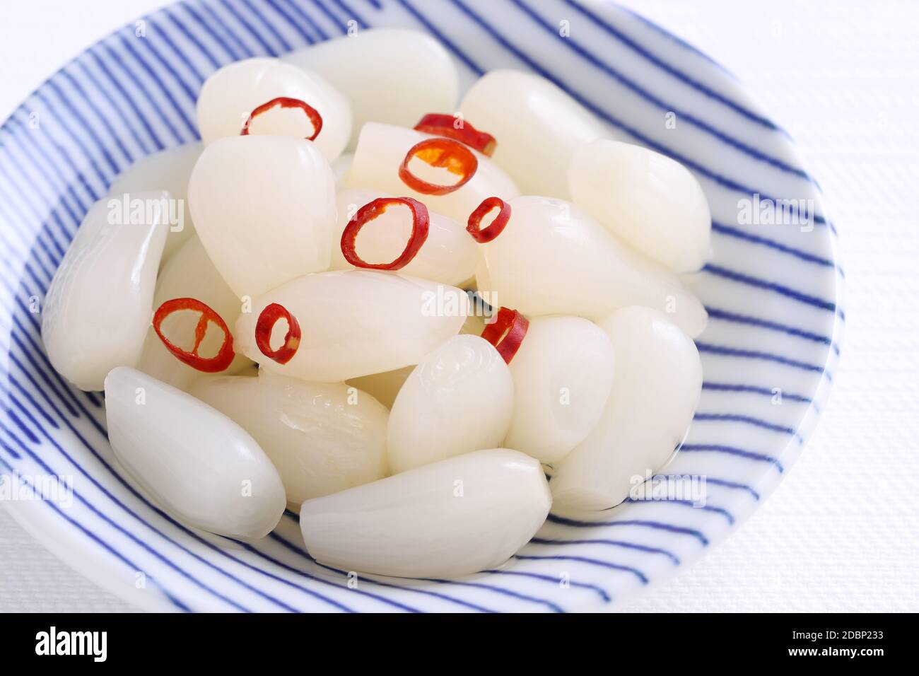 Japanese Rakkyo, Sweet and sour pickled scallions in a dish Stock Photo