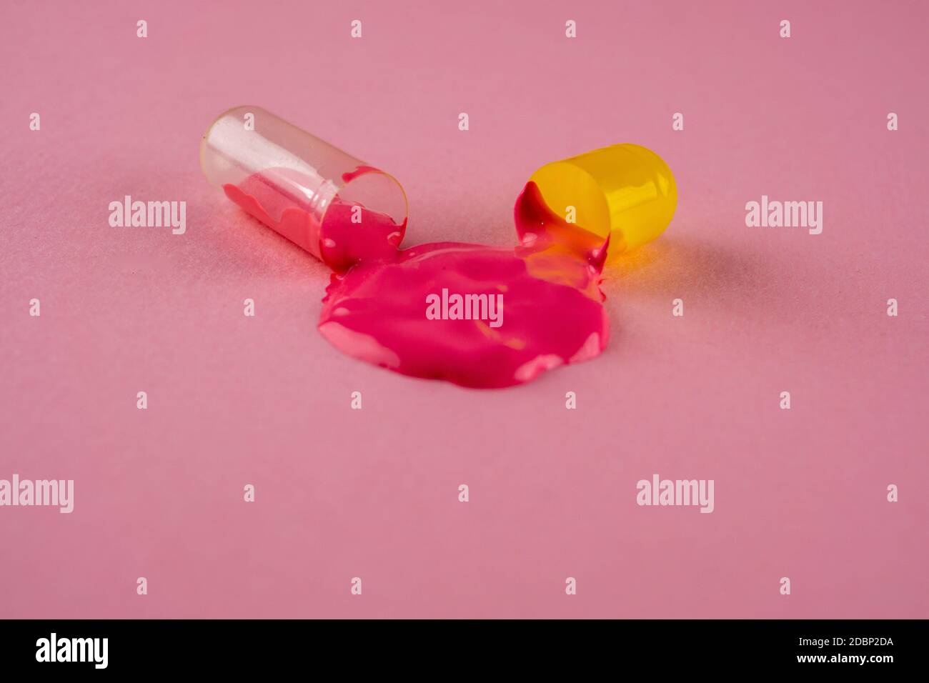 Creative layout of open pill with dripping paint. Macro shot Stock