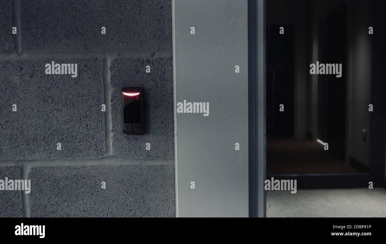 Smart security fob entry door lock to a residential building corridor. Red light showing no entry. Stock Photo