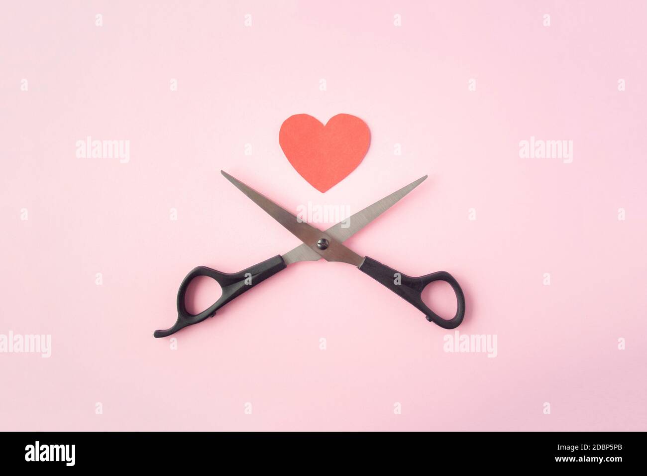 Scissors with red heart top view on pink background. Concept of divorce. Divorce proceedings, law, court, family break, pain Stock Photo