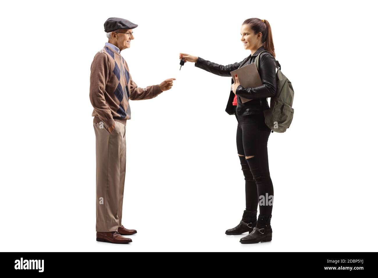 Full length profile shot of a female student giving car keys to an elderly man isolated on white background Stock Photo